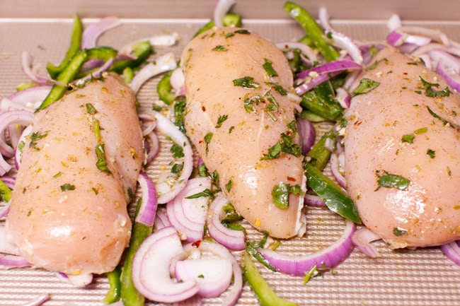 Cilantro Lime Chicken from thelittlekitchen.net chicken, red onions and bell peppers on a baking sheet