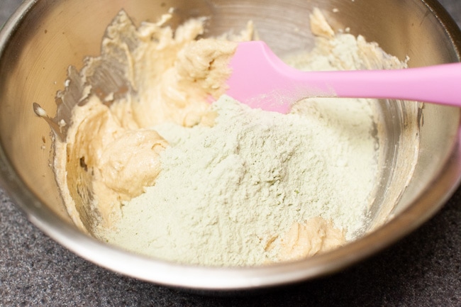 Matcha Cookies from thelittlekitchen.net Adding dry mixture to wet mixture in metal mixing bowl for Matcha Cookies from thelittlekitchen.net