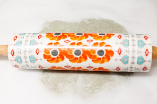 Matcha Cookies from thelittlekitchen.net Matcha Cookie dough being rolled out under parchment paper with colorful rolling pin from thelittlekitchen.net