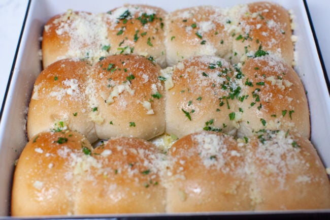 Place frozen Rhodes Bake N Serve Yeast Dinner Rolls in evenly spaced apart. garlic rolls in a baking dish
