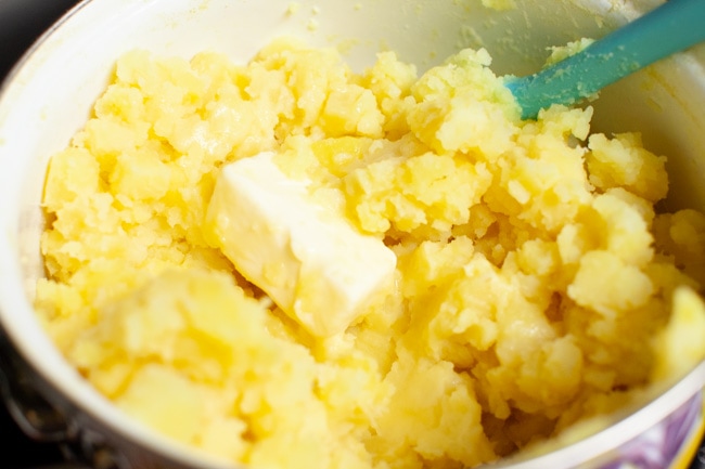 How to Make the Perfect Mashed Potatoes mashed potatoes in a pot with butter