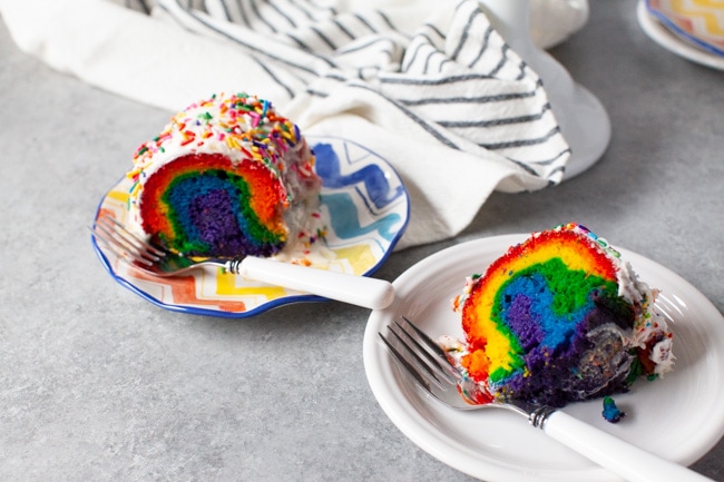 Rainbow Bundt Cake from thelittlekitchen.net Two slices of rainbow cake on two plates with forks