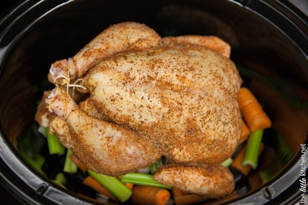 Slow Cooker Whole Chicken and Vegetables from TheLittleKitchen.net whole chicken with spices placed on top of vegetables in a slow cooker